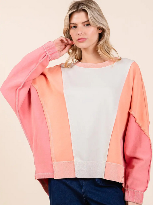 Woman wearing a colorful sweater with a beige background