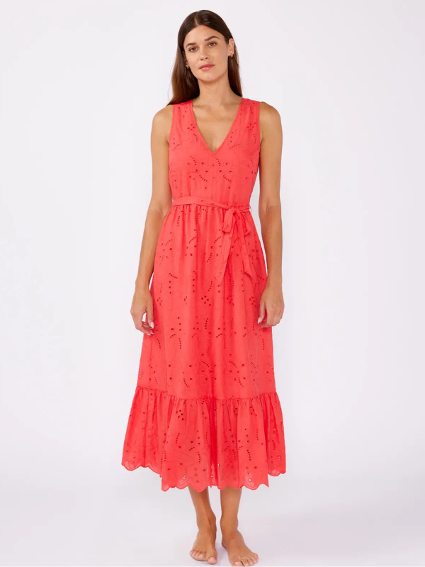 Woman wearing a coral dress on a white background