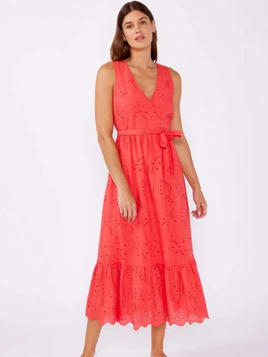 Woman wearing a coral dress with a white background