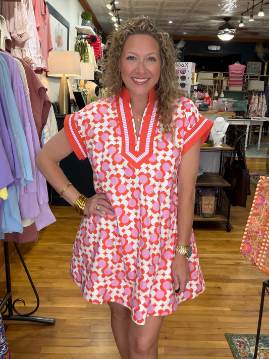 Woman wearing a colorful dress in a store setting