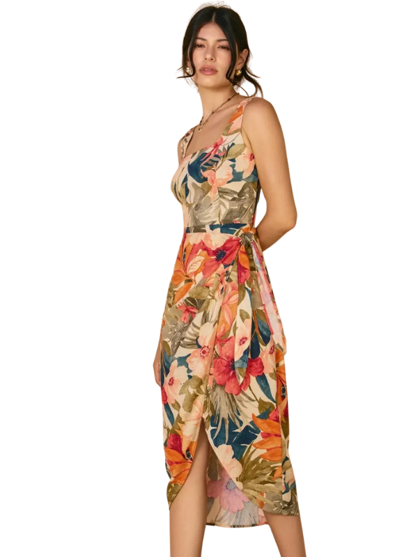 Woman wearing a colorful floral dress on a white background