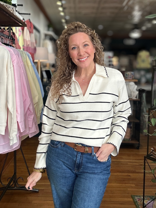 Woman wearing a striped shirt and jeans in a store setting