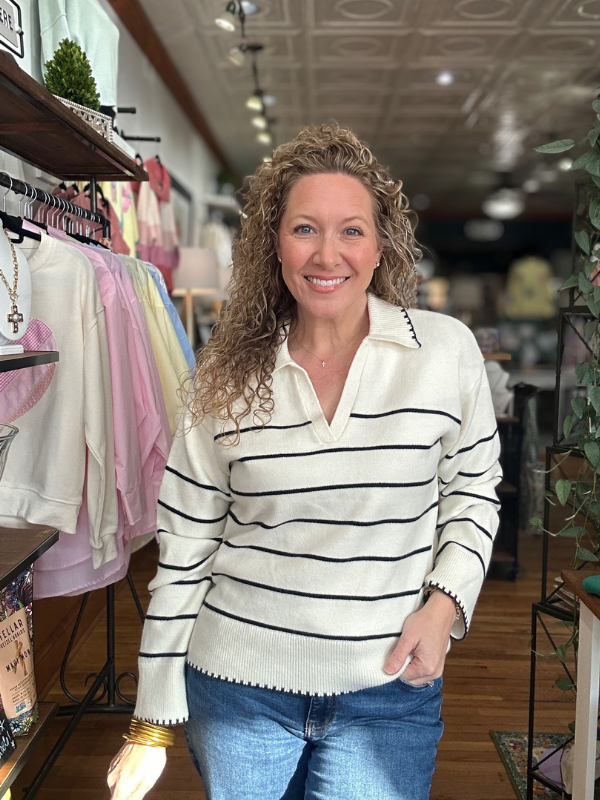 Woman wearing a striped sweater in a store setting