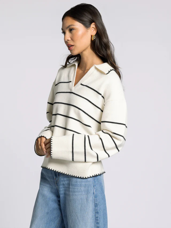 woman wearing cream sweater with black stripes