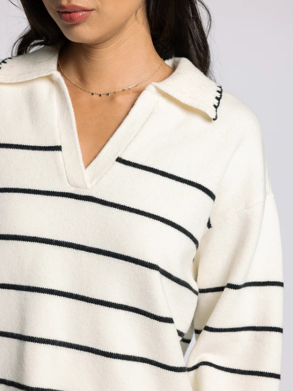 woman wearing cream sweater with black stripes