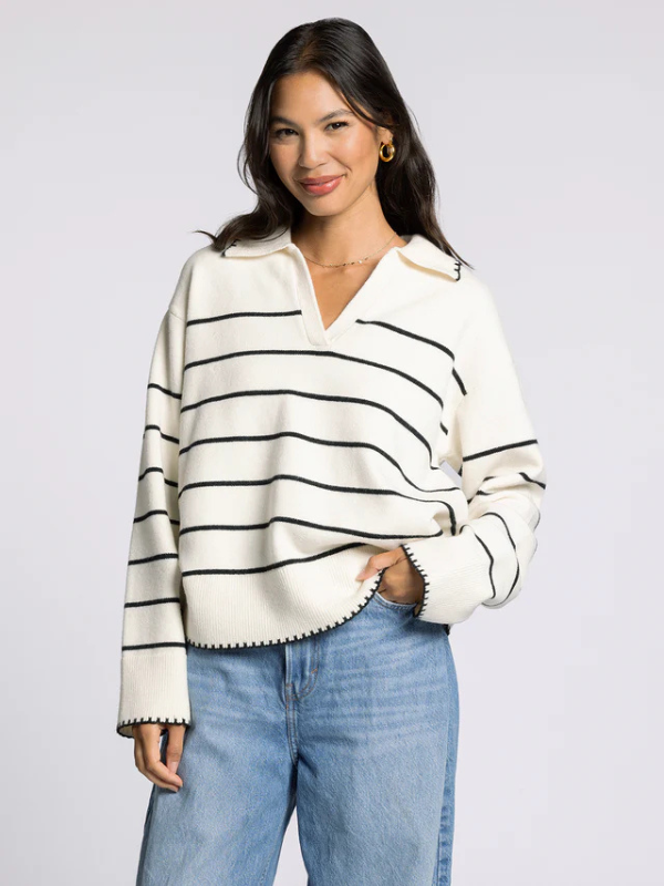 woman wearing cream sweater with black stripes