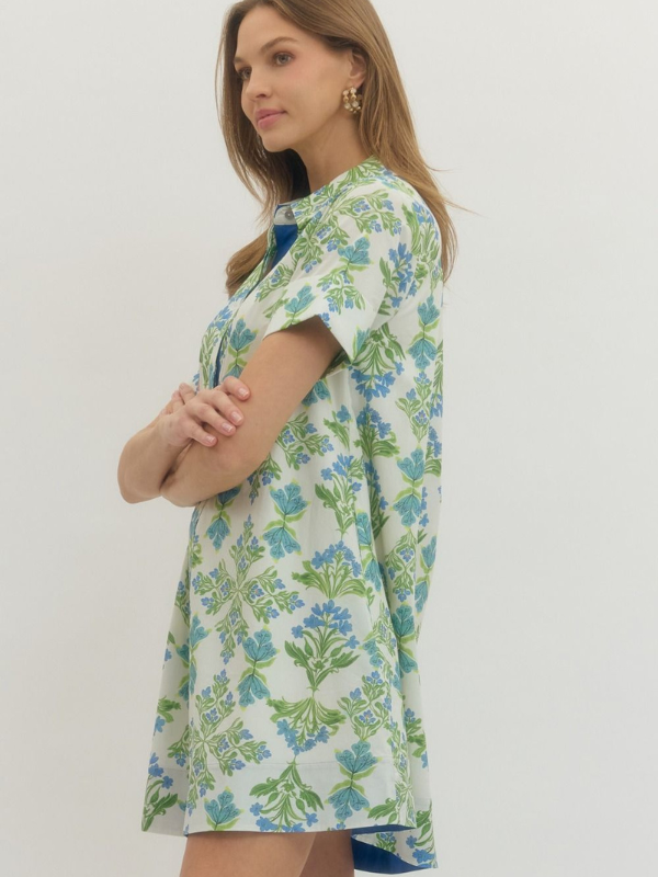 Woman wearing a floral patterned dress against a plain background