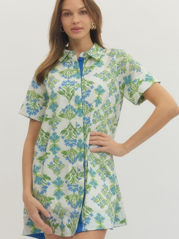 Woman wearing a floral dress with a plain background