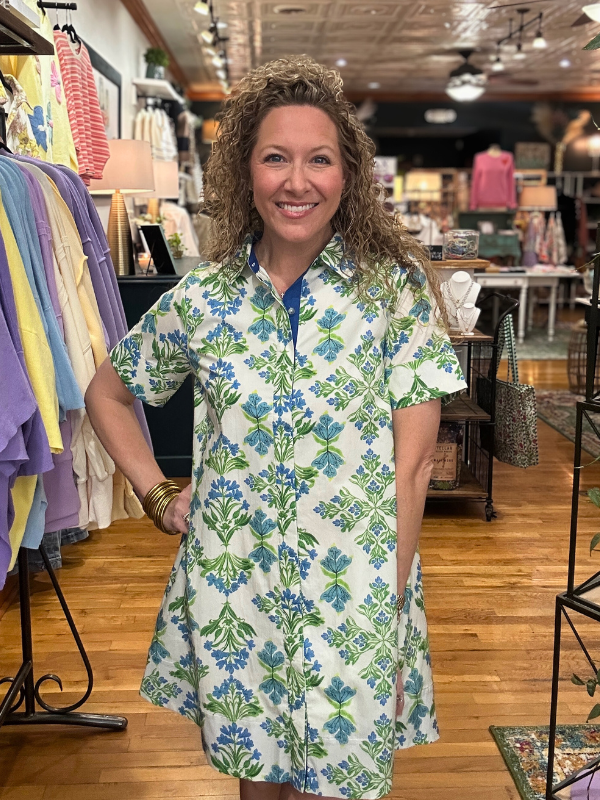 Woman wearing a floral dress in a store setting