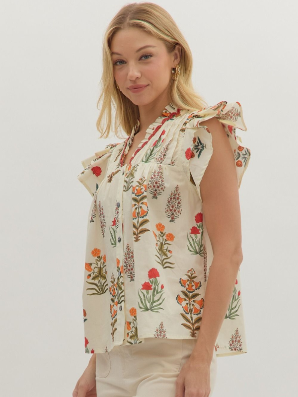Woman wearing a floral blouse against a plain background