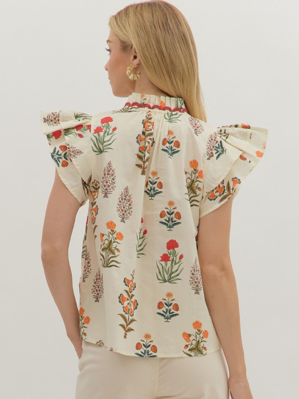 Woman wearing a floral blouse with a plain background