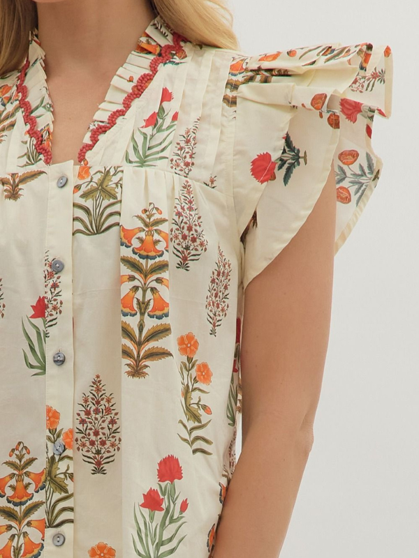 Floral patterned shirt worn by a person on a white background