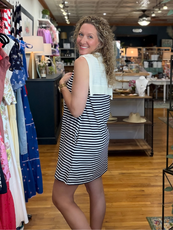 Woman in a striped dress standing in a clothing store