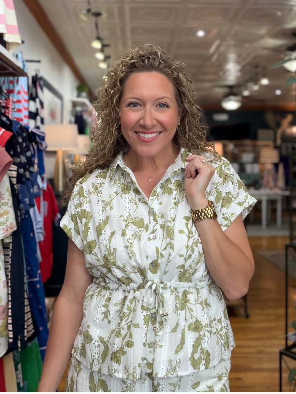 Woman wearing a floral dress in a store setting