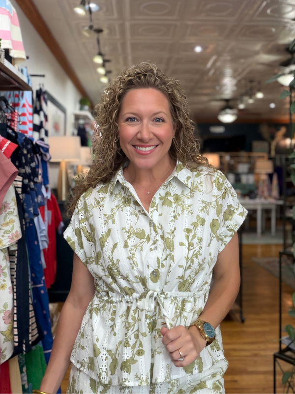 Woman wearing a floral dress in a store setting