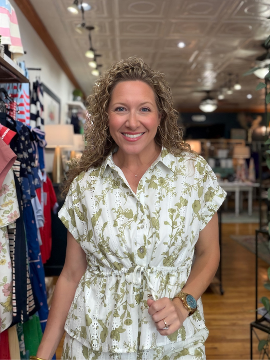 Woman wearing a floral dress in a store setting