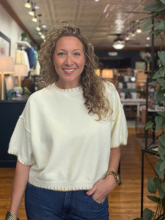woman wearing a cream blanket stitched sweater 