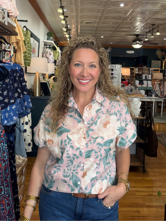 Woman wearing a floral shirt in a store setting