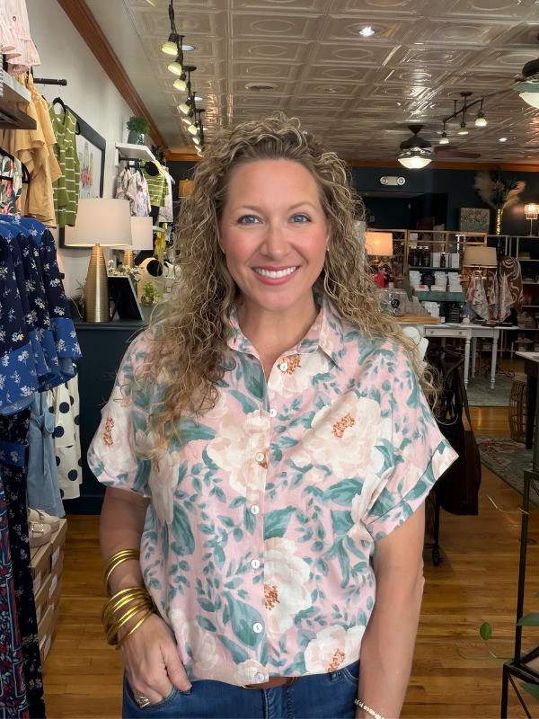 Woman wearing a floral shirt in a store setting