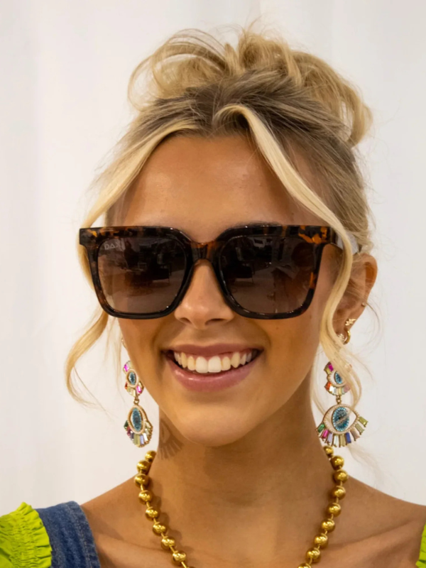 woman wearing sunglasses with brown cheetah frames and brown lenses