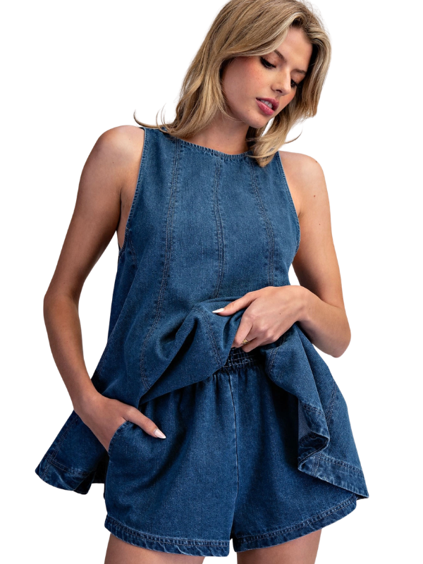 Woman wearing a blue denim dress on a white background