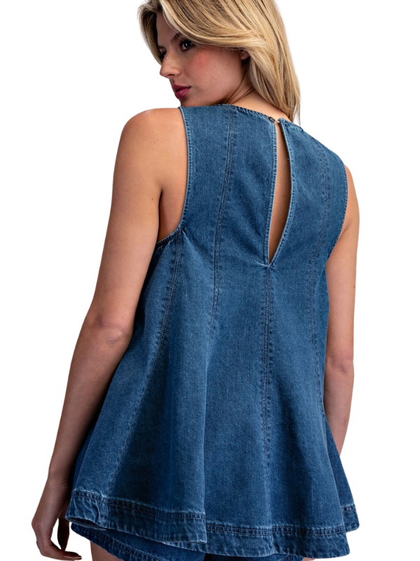 Blue denim sleeveless top worn by a model on a white background