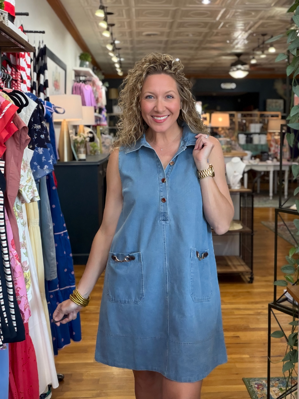 Woman wearing a blue dress in a clothing store