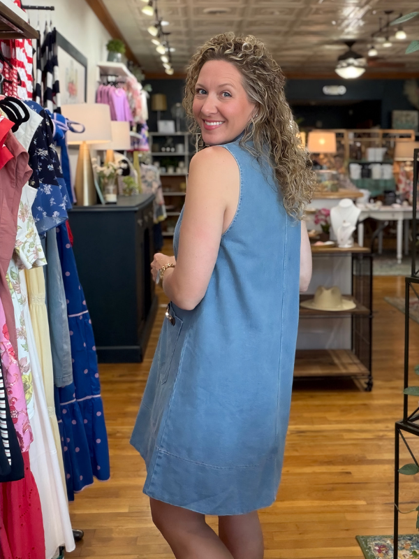 Woman wearing a blue dress in a clothing store