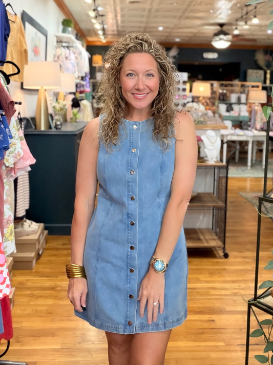 Woman wearing a blue denim dress in a store setting
