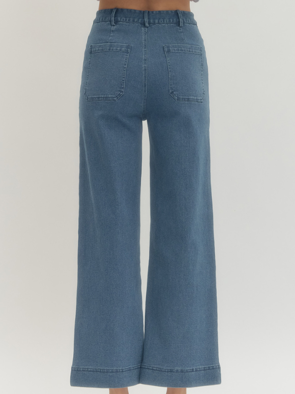 Blue denim wide-leg jeans on a plain background