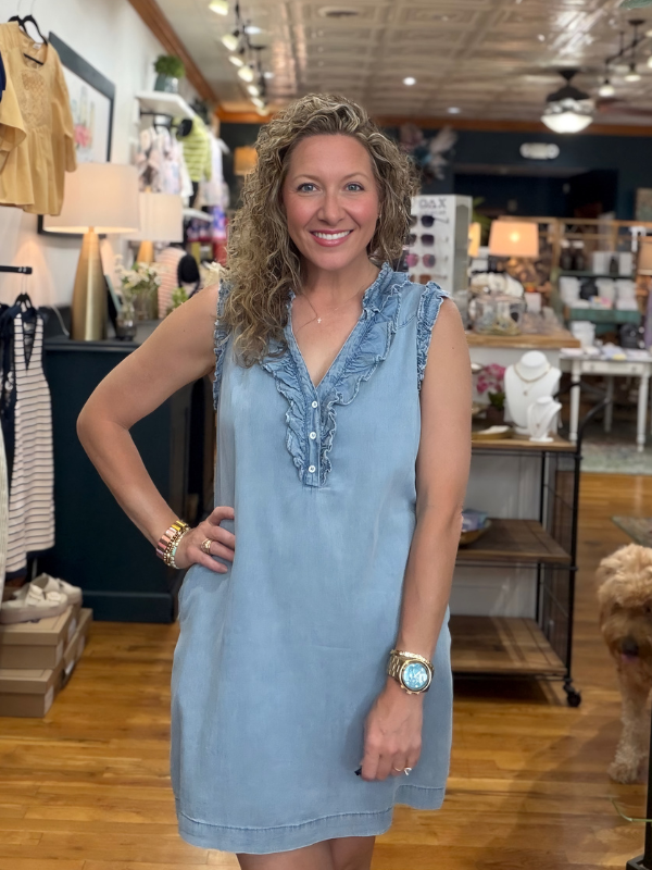 Woman wearing a blue dress in a store setting