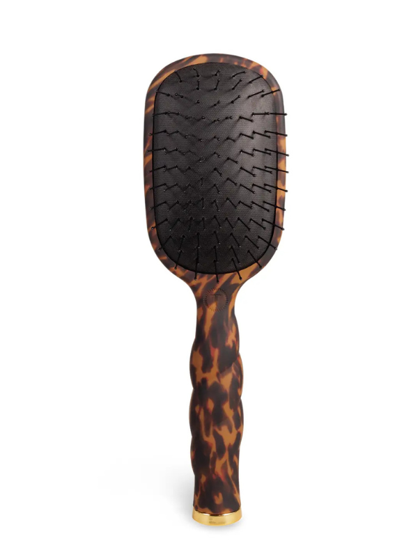 Tortoiseshell paddle hairbrush on a white background