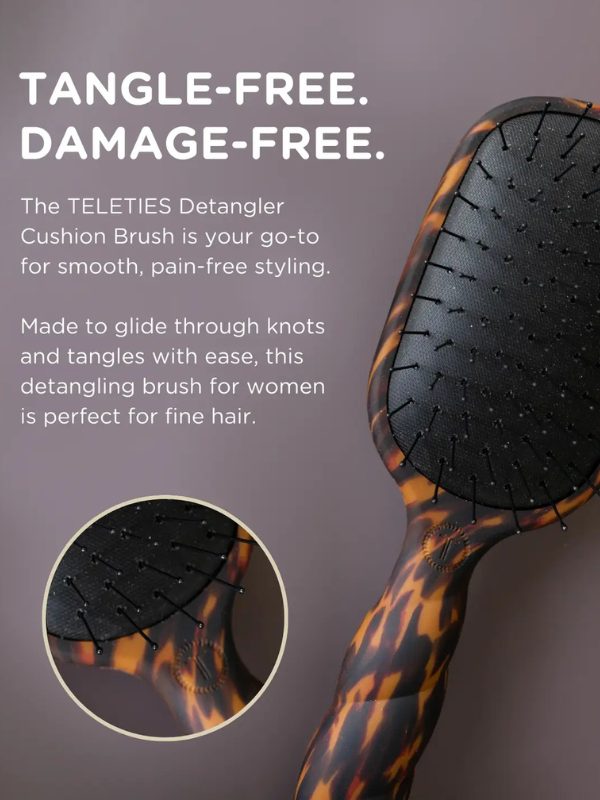 TELETIES Detangler Cushion Brush with tortoiseshell handle on a gray background