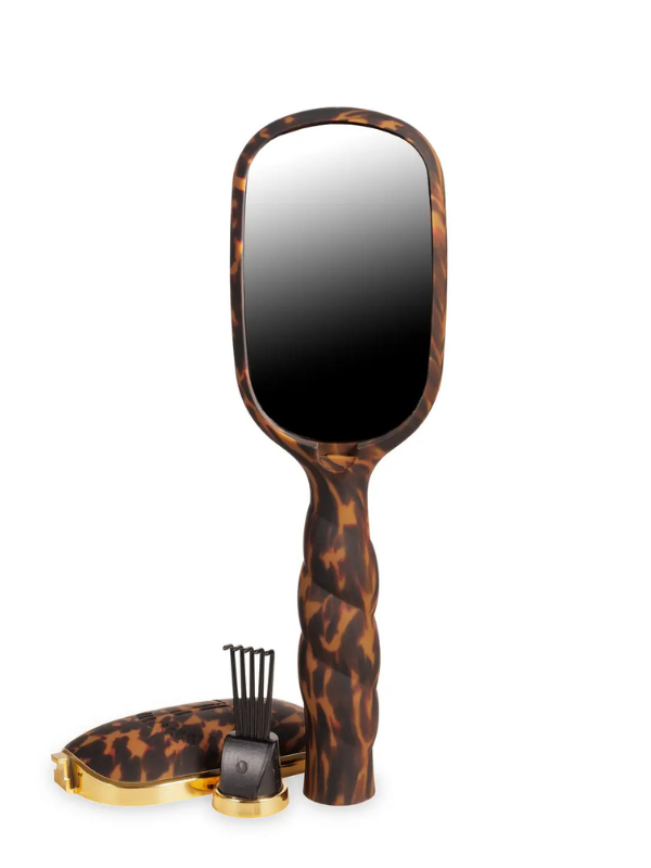 Tortoiseshell-handled mirror with a black center on a white background