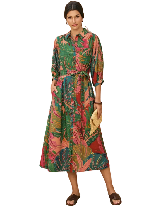 Woman wearing a colorful patterned dress on a white background