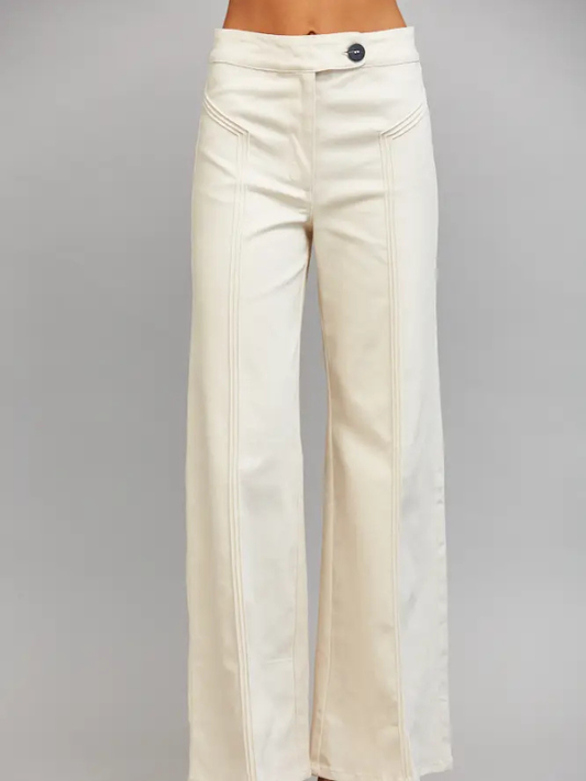 Cream wide-leg pants with vertical seam detailing and a single button closure at the waist, shown on a model against a neutral gray background.