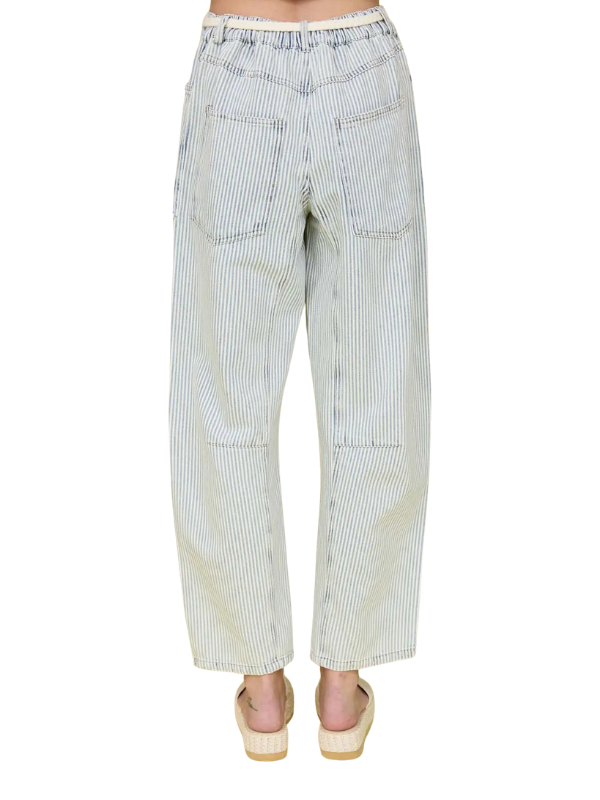 Striped pants worn by a person on a white background