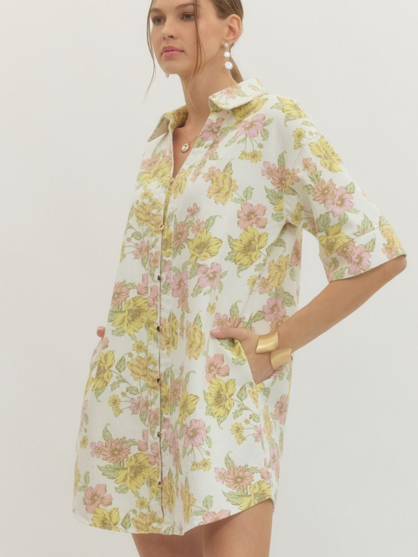 Woman wearing a floral dress with a plain background