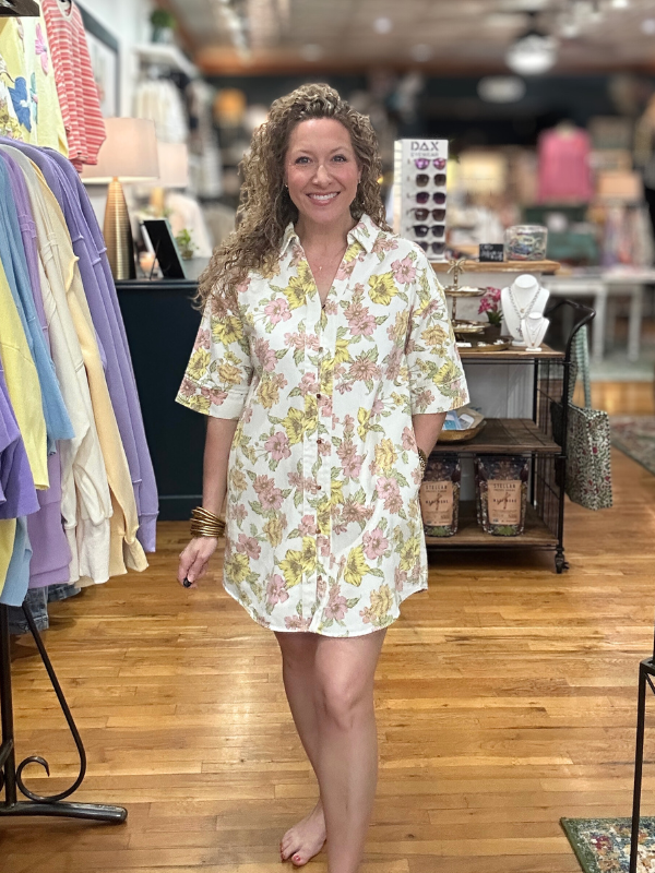 Woman wearing a floral dress in a store setting