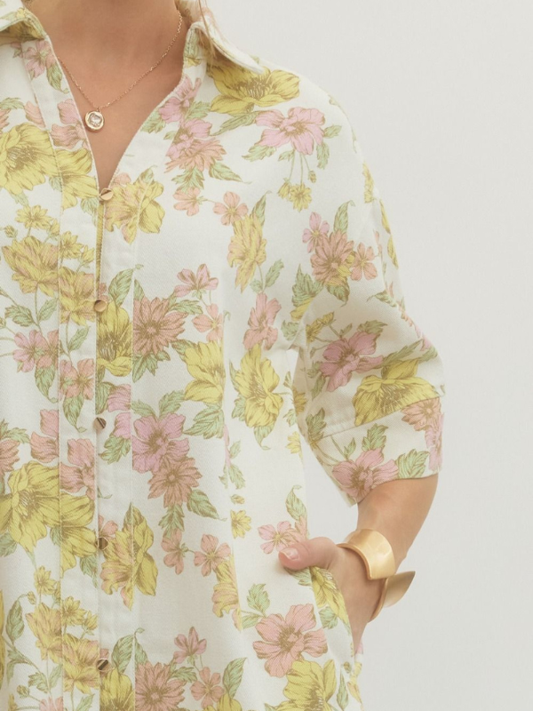 Floral patterned shirt worn by a person on a plain background