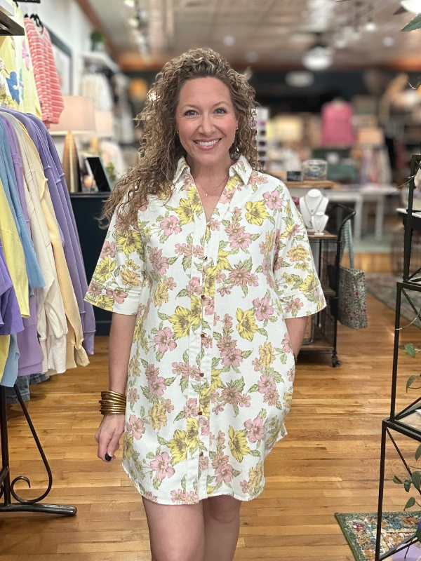 Woman wearing a floral dress in a store setting