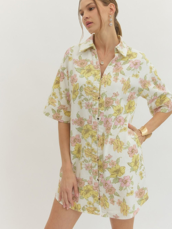 Woman wearing a floral dress with a plain background