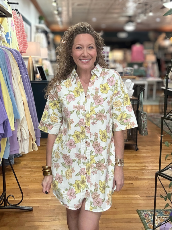 Woman wearing a floral dress in a clothing store