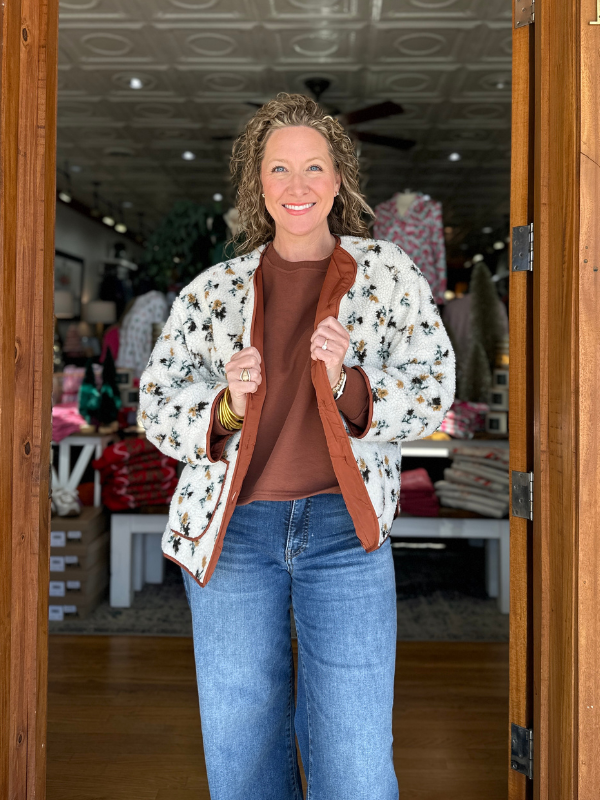 Woman holding a brown bag in a store setting