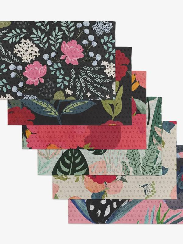 Set of colorful floral-patterned placemats on a white background