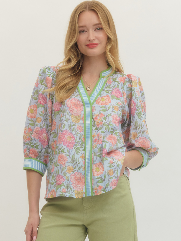 Woman wearing a floral blouse with a plain background