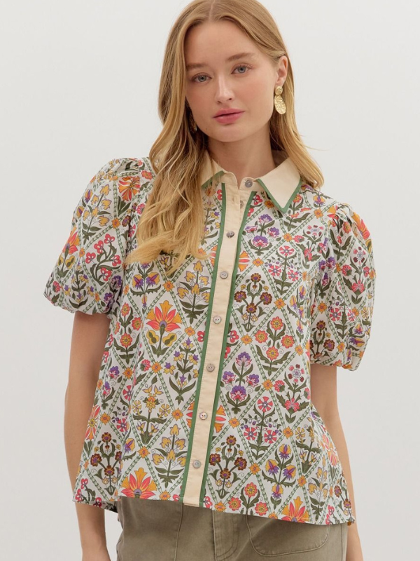 Woman wearing a floral blouse with a plain background