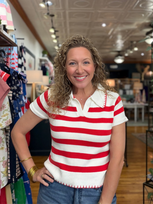 Woman wearing a red and white striped shirt in a store setting