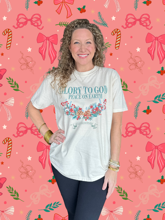 Woman wearing a white t-shirt with Christmas-themed design on a festive background with bows and candy canes.