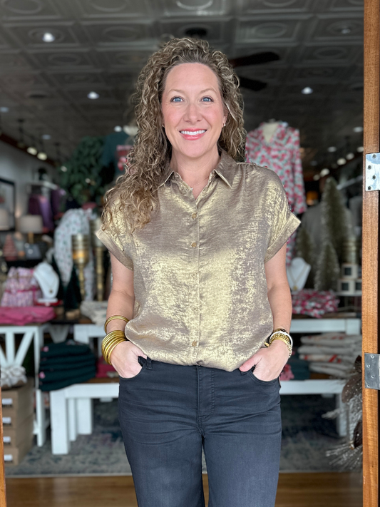 Woman wearing a gold metallic shirt in a store setting
